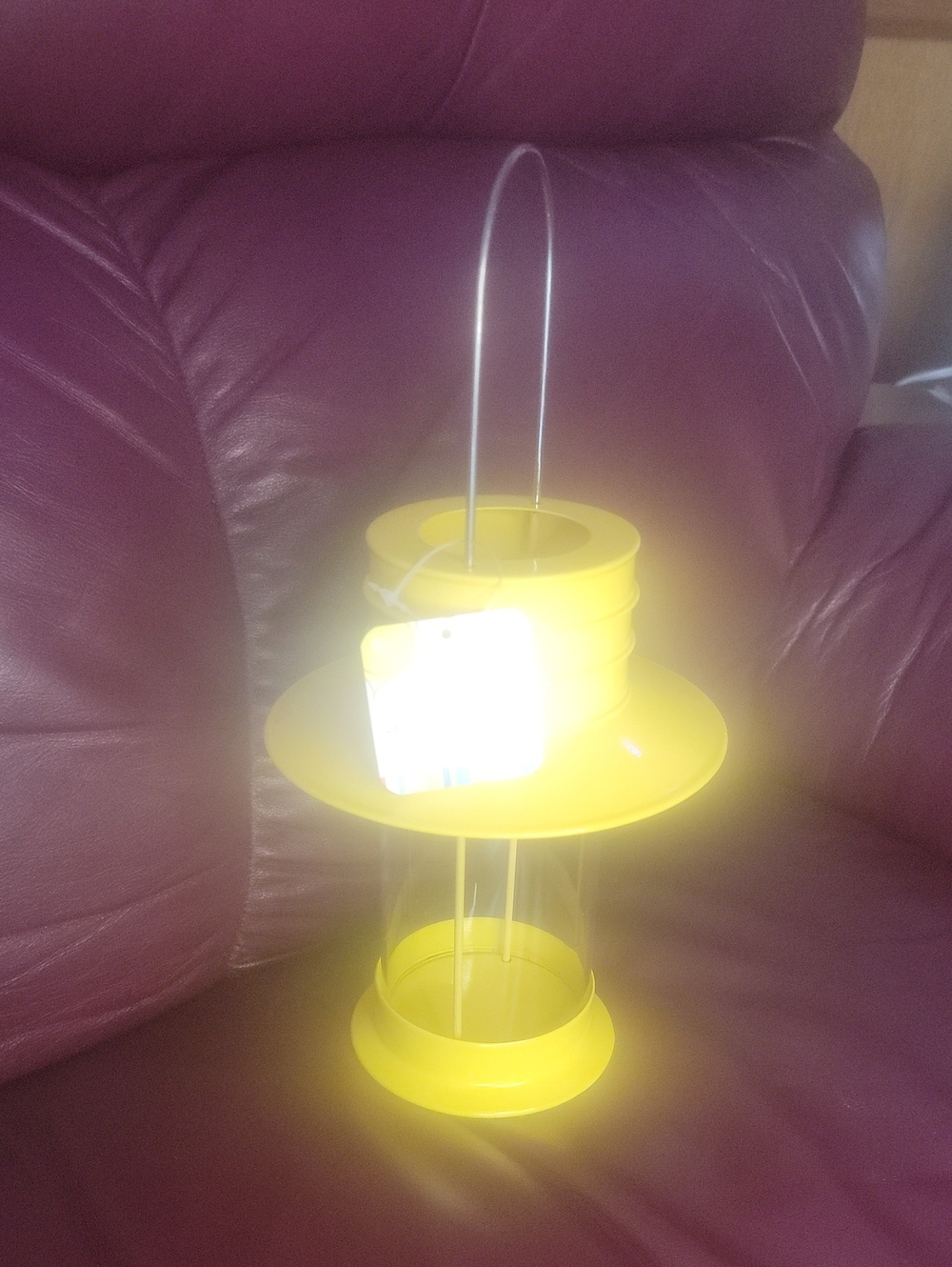 bright yellow metal and glass tealight candle holder labeled "SO HOT WAY COOL LA